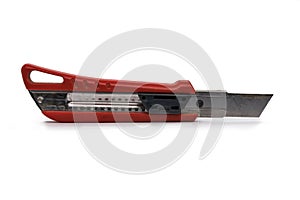 Used red snap-off utility knife with blade out isolated on white