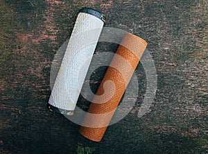 Used rust filled home water filters or cartridges from osmosis systems on wooden textured background.