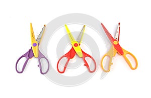 Used serrated color scissors on white background