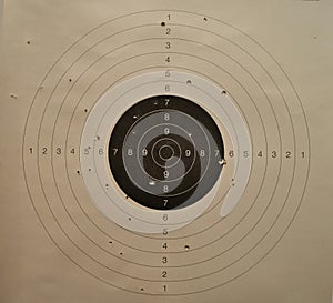 Used shooting paper target with bullet holes