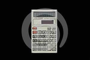 Used simple pocket calculator on isolated bkack background top view.
