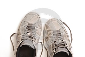 Used sneakers isolated on white. Casual dirty footwear. Urban
