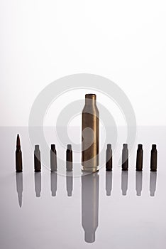 Used spent shells of cartridges from a machine gun and a machine gun on a white background