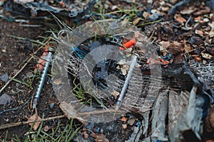 Used syringes lie on the ground