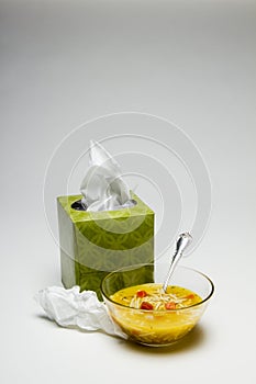 Used tissue and chicken noodle soup, vertical