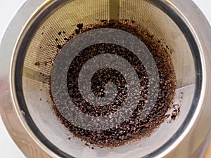 Used wet used coffee grounds in a coffee percolator funnel photo