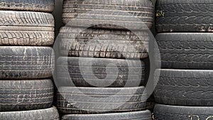 Used wheel tires stacked ready for recycling.