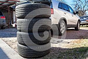 Used wheels with summer tires for suv car stacking on earth, seasonal tyre change