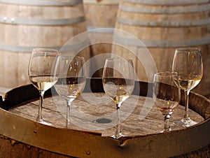 Used wine glasses on an old wine barrel