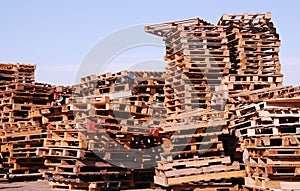 Used wooden pallets stacked under open sky