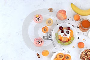 Useful breakfast with ingredients, flat lay, fruit salad with granola, apricots, bananas, honey and peaches on a bright table. The