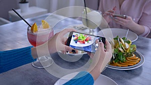 Useful food, arm of blogger woman using cell phone for photo of vegetarian eating during healthy lunch for social