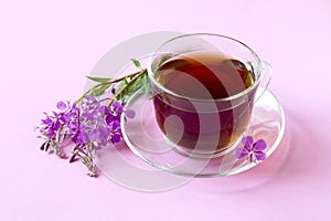 Useful herbal tea from fermented leaves fireweed on pink background