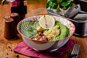 Useful Italian vegan food. Vegetarian bowl for breakfast of porridge couscous, avocado, cucumber, Brussels sprouts and vegetable