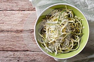 Useful raw zucchini pasta in a bowl close up. horizontal top vie