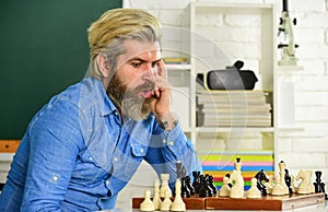 Usefulness of chess. mature man playing intellectual game. clever man play chess. chess board with chess pieces
