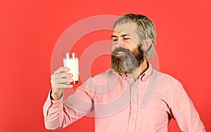 Usefulness of milk. dairy products from milk for adults and children. happy farmer present glass. bearded man drink