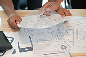 User experience UX designer designing web on smart phone layout. UI developer planning working on mobile application prototype