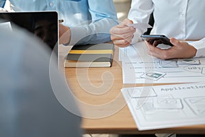 User experience UX designer designing web on smart phone layout. UI developer planning working on mobile application prototype