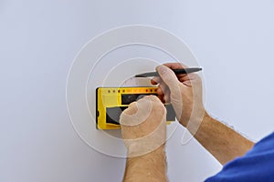 Uses Multi-Sense Technology to find studs more accurately through difficult surfaces. Man hand is scanning wall by