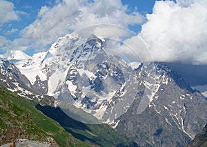 Ushba mountain, rocky peaks and stones with snow in Caucasian mountains in Georgia