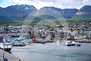 Ushuaia, Capital of Tierra del Fuego, Patagonia, Argentina. Colorful houses, boats on sea, hills and mountains.