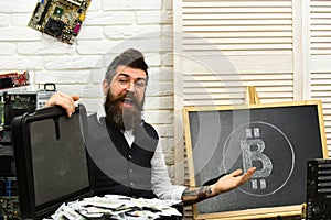Using Bitcoin to transact is easy. Bearded hipster with bitcoin symbol and dollars. Bearded man with cash money photo