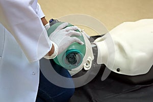 Using a Breathing bag Ambu by a student on a simulation dummy during basic life support with an automatic external defibrillator