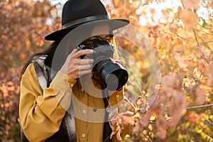 Using camera, close-up of female photographer during shooting landscape view