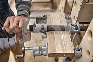 Using clamps and glue to connect wooden timbers for furniture detail