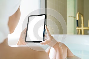 Using digital tablet, Women holding digital tablet while soaking