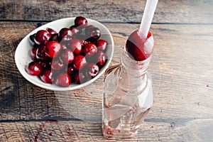 Using a Drinking Straw and a Bottle to Pit Fresh Cherries