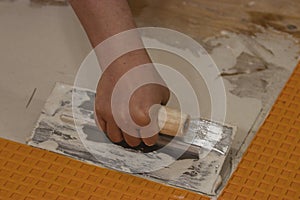 using a flat square trowel to smooth and spread cement