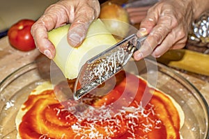 Using a grater to grate cheese