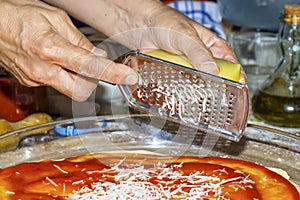 Using a grater to grate cheese