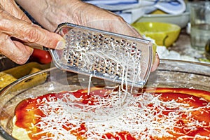 Using a grater to grate cheese