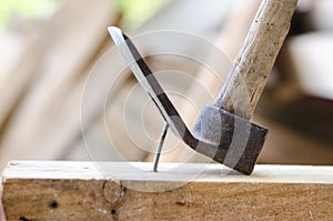 Using hammer and nail on wood and bokeh background