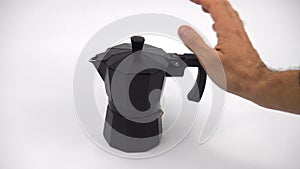 Using hand to close open the top and rotate a stovetop expresso coffee maker isolated