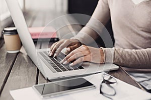 Using laptop at cafe. Business woman working on computer at home.