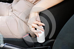 using Medication Before Driving concept with Woman's Hand Holding Medicine Bottle Inside a Car