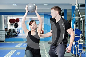 Using medicine ball with personal trainer photo