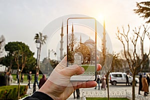 Using a mobile phone camera to take pictures of the Blue Mosque, Sultanahmet in Istanbul, Turkey.