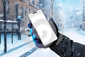 Using a mobile phone on the street while it is snowing