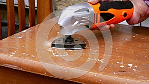 Using a power multi tool to sand old furniture