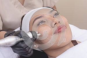 Using an RF electromagnetic device for radiofrequency skin tightening or contouring treatment. At a facial care, dermatologist or