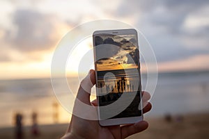 Using a Samrtphone. Photographing sunset on a mobile phone