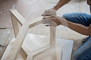 Using sandpaper scrub plank wood for making table, furniture