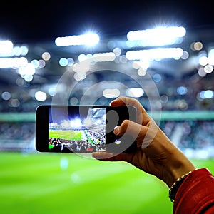 Using a smartphone camera for photographing a football game in the stadium