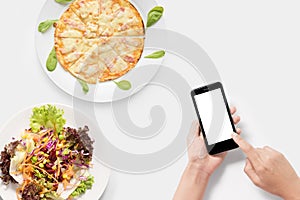 Using smartphone with pizza, salad set isolated isolated on whit