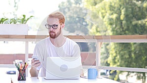 Using Smartphone, Sitting in utdoor Office, Red Hairs